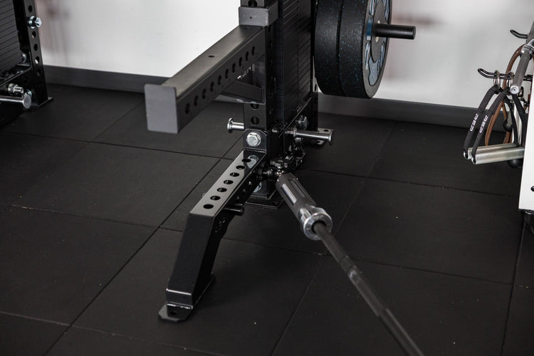 Front Foot Extension Pair 2.0 on power rack in gym setting with tile flooring