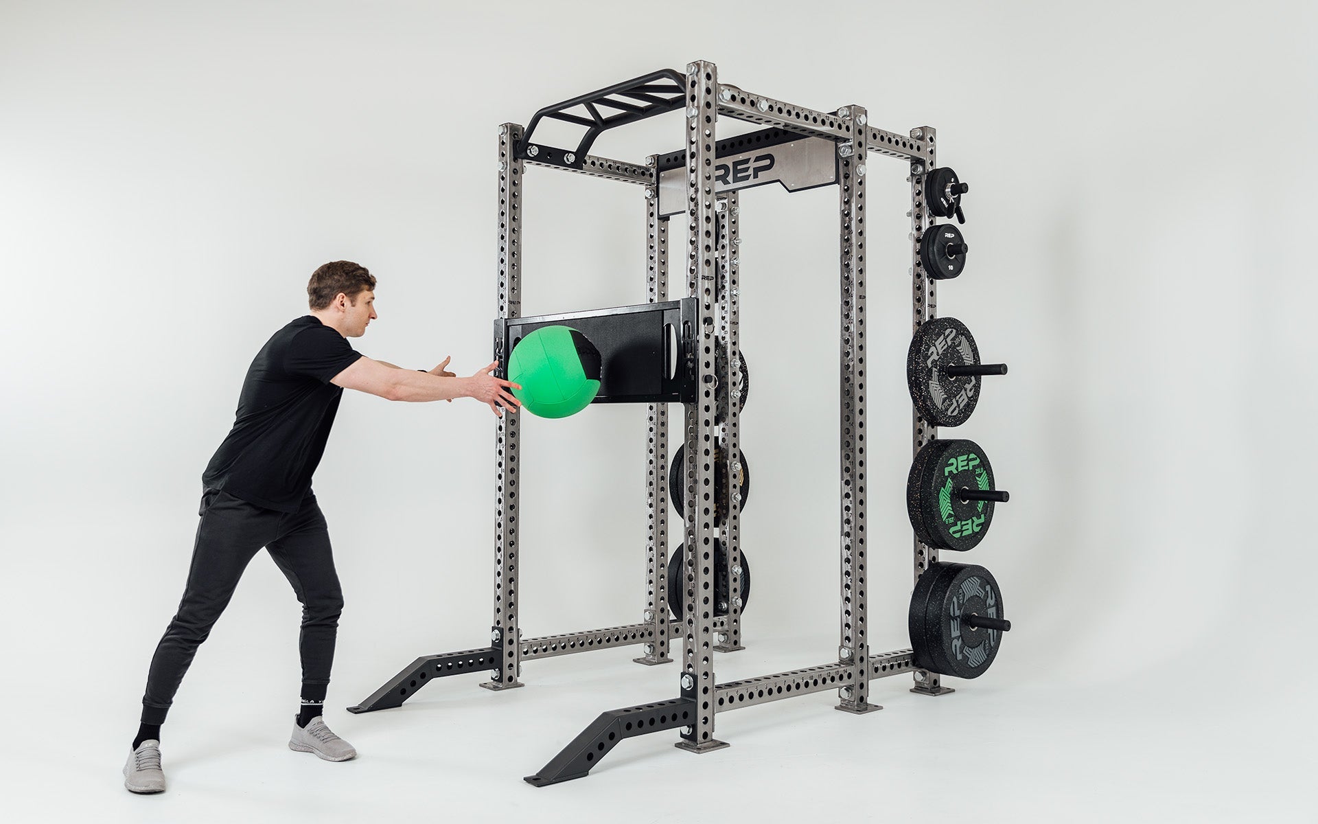 Utility Seat Installed on Uprights on Power Rack Being Used for Ball Tosses