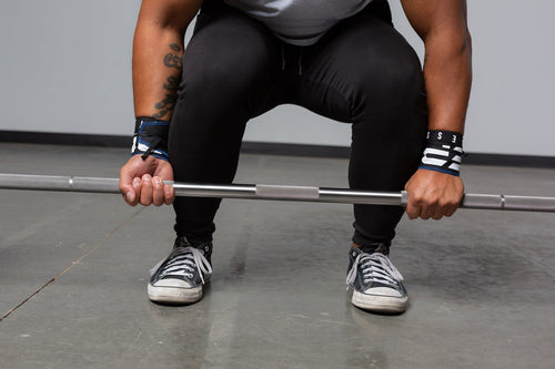 Powerlifter deadlifting on a power bar
